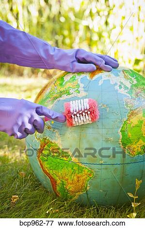 Woman wearing rubber gloves to scrub globe outdoors View Large Photo Image Stock Photo - Woman wearing rubber gloves to scrub globe outdoors. Fotosearch
