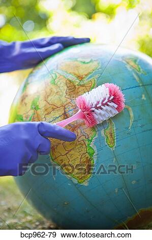 Woman wearing rubber gloves to scrub globe outdoors View Large Photo Image Stock Photo - Woman wearing rubber gloves to scrub globe outdoors. Fotosearch
