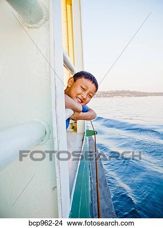 Young boy looking out ferry window View Large Photo Image Picture - Young boy looking out ferry window. Fotosearch