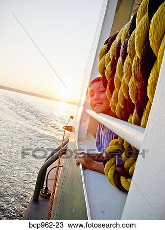 Young boy looking out ferry window View Large Photo Image Stock Image - Young boy looking out ferry window. Fotosearch