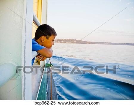 Young boy looking out ferry window View Large Photo Image Stock Photography - Young boy looking out ferry window. Fotosearch
