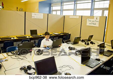 Young boy seated at school laptop in computer lab View Large Photo Image Stock Photo - Young boy seated at school laptop in computer lab. Fotosearch