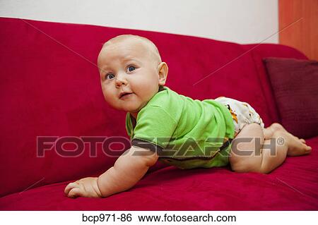 Baby crawling on red sofa View Large Photo Image Stock Photograph - Baby crawling on red sofa. Fotosearch