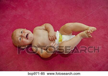 Stock Photography - Baby on red background. Fotosearch
