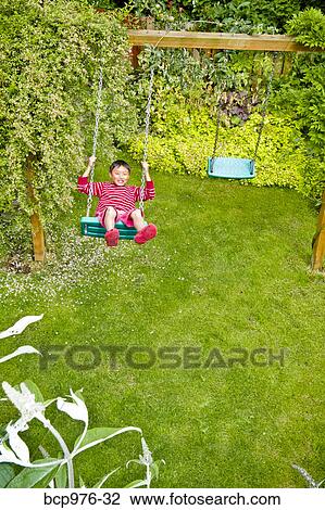 Boy on backyard swing View Large Photo Image Stock Image - Boy on backyard swing. Fotosearch