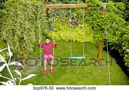 Boy on backyard swing View Large Photo Image Stock Image - Boy on backyard swing. Fotosearch
