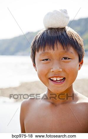 Boy with moonsnail shell on his head View Large Photo Image Stock Photo - Boy with moonsnail shell on his head. Fotosearch