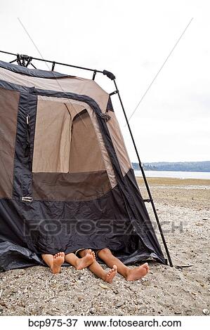 Stock Photo - Children playing in tent on beach. Fotosearch