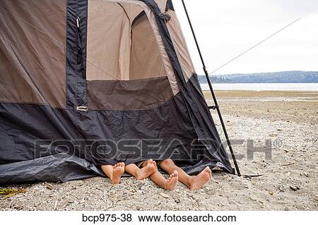 Stock Photo - Children playing in tent on beach. Fotosearch