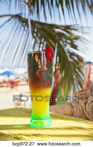 Colorful drink on seaside table View Large Photo Image Stock Photo - Colorful drink on seaside table. Fotosearch