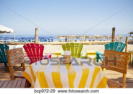Stock Photo - Colorful seaside table and chairs. Fotosearch