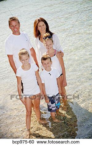 Family standing in shallow water View Large Photo Image Stock Image - Family standing in shallow water. Fotosearch