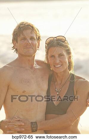 Happy couple on beach in swimsuits View Large Photo Image Stock Photography - Happy couple on beach in swimsuits. Fotosearch