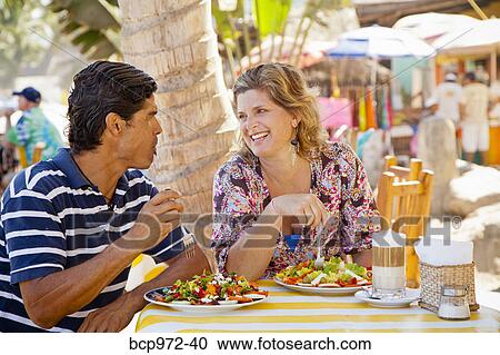Man and woman eating at outdoor café View Large Photo Image Stock Image - Man and woman eating at outdoor café. Fotosearch