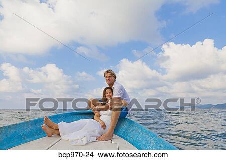 Man and woman embracing in bow of boat View Large Photo Image Picture - Man and woman embracing in bow of boat. Fotosearch