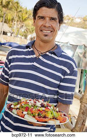Man holding platter of mexican food View Large Photo Image Stock Image - Man holding platter of mexican food. Fotosearch