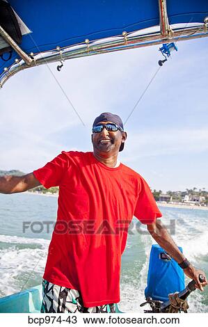Man running fishing charter boat View Large Photo Image Stock Image - Man running fishing charter boat. Fotosearch