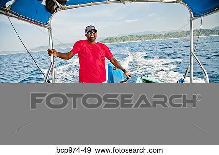 Man running fishing charter boat View Large Photo Image Stock Photo - Man running fishing charter boat. Fotosearch