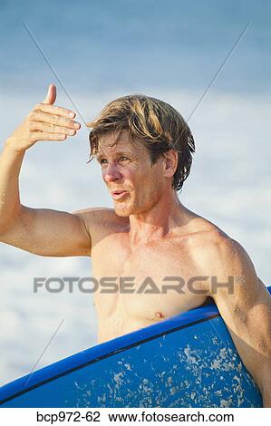 Stock Image - Man with surfboard. Fotosearch