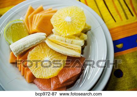 Place setting with plate of fruit View Large Photo Image Stock Photo - Place setting with plate of fruit. Fotosearch
