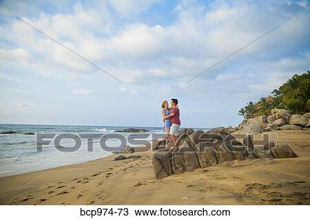 Stock Image - Romantic young couple on beach. Fotosearch