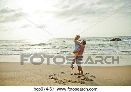 Romantic young couple on beach View Large Photo Image Stock Photo - Romantic young couple on beach. Fotosearch