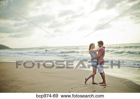 Stock Photo - Romantic young couple on beach. Fotosearch