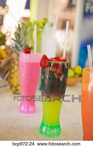 Picture - Row of colorful drinks on counter. Fotosearch