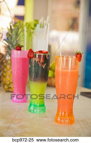 Row of colorful drinks on counter View Large Photo Image Stock Photography - Row of colorful drinks on counter. Fotosearch