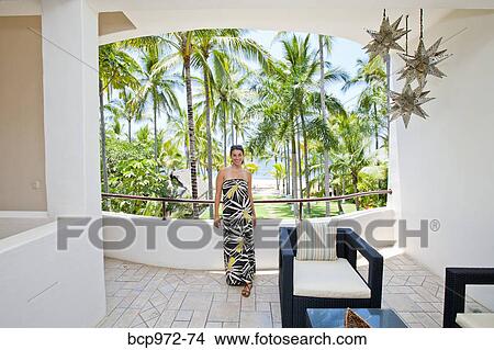Picture - Stylish woman in house near palm trees. Fotosearch