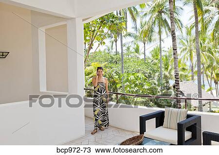 Stylish woman in house near palm trees View Large Photo Image Stock Image - Stylish woman in house near palm trees. Fotosearch