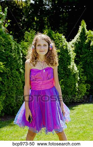 Teen girl in party dress listening to music outdoors View Large Photo Image Stock Image - Teen girl in party dress listening to music outdoors. Fotosearch