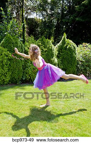 Teen girl in party dress listening to music outdoors View Large Photo Image Stock Photo - Teen girl in party dress listening to music outdoors. Fotosearch