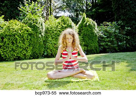 Teen girl meditating outdoors View Large Photo Image Stock Photography - Teen girl meditating outdoors. Fotosearch
