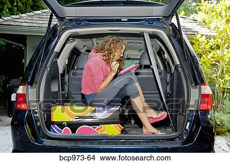 Teen girl with luggage in car View Large Photo Image Picture - Teen girl with luggage in car. Fotosearch