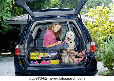 Teen girl with shopping bags and dog in car View Large Photo Image Stock Image - Teen girl with shopping bags and dog in car. Fotosearch