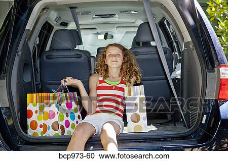 Teen girl with shopping bags in car View Large Photo Image Stock Image - Teen girl with shopping bags in car. Fotosearch