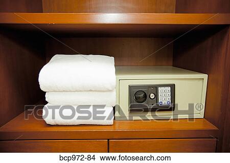 Picture - Towels stacked next to hotel safe. Fotosearch