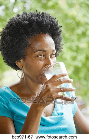 Woman drinking glass of water View Large Photo Image Stock Photo - Woman drinking glass of water. Fotosearch
