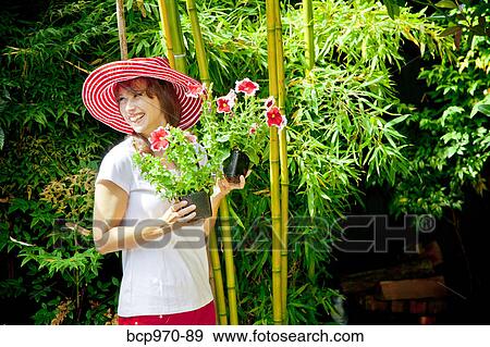Woman holding plants outdoors View Large Photo Image Stock Photo - Woman holding plants outdoors. Fotosearch