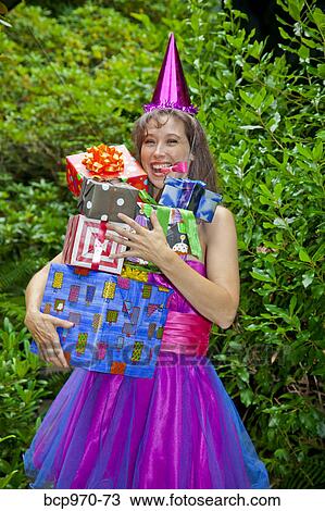 Woman in party clothes holding presents View Large Photo Image Stock Image - Woman in party clothes holding presents. Fotosearch