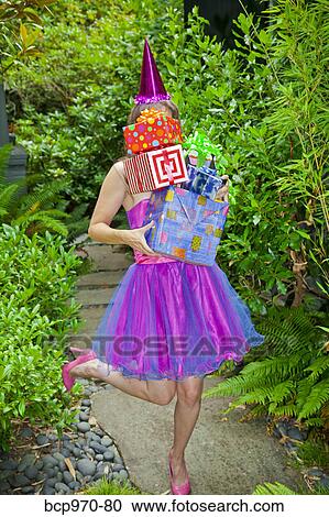 Woman in party clothes holding presents View Large Photo Image Stock Image - Woman in party clothes holding presents. Fotosearch