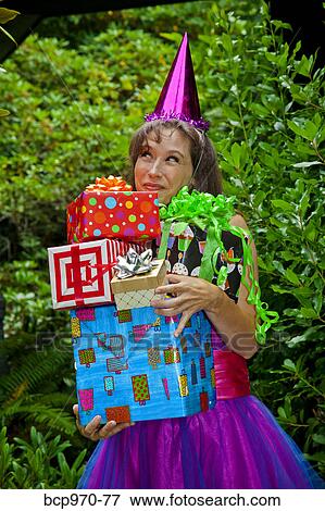 Woman in party clothes holding presents View Large Photo Image Stock Photo - Woman in party clothes holding presents. Fotosearch