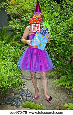 Woman in party clothes holding presents View Large Photo Image Stock Photo - Woman in party clothes holding presents. Fotosearch