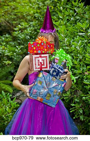 Woman in party clothes holding presents View Large Photo Image Stock Photo - Woman in party clothes holding presents. Fotosearch
