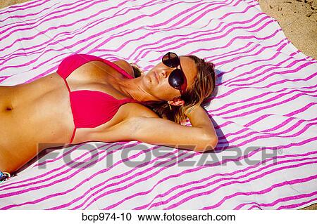 Woman in sunglasses sunbathing View Large Photo Image Stock Image - Woman in sunglasses sunbathing. Fotosearch