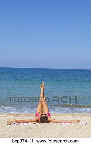 Woman on beach enjoying sun View Large Photo Image Stock Image - Woman on beach enjoying sun. Fotosearch