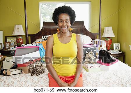 Woman on bed with shopping bags and shoes View Large Photo Image Stock Photo - Woman on bed with shopping bags and shoes. Fotosearch