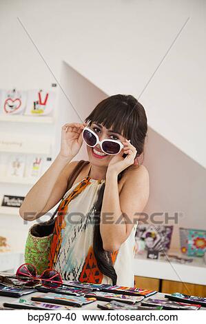 Woman shopping for sunglasses View Large Photo Image Stock Image - Woman shopping for sunglasses. Fotosearch