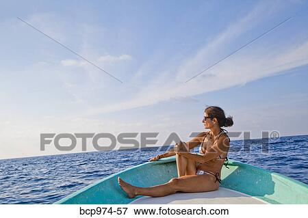 Woman sitting in bow of boat View Large Photo Image Stock Photo - Woman sitting in bow of boat. Fotosearch